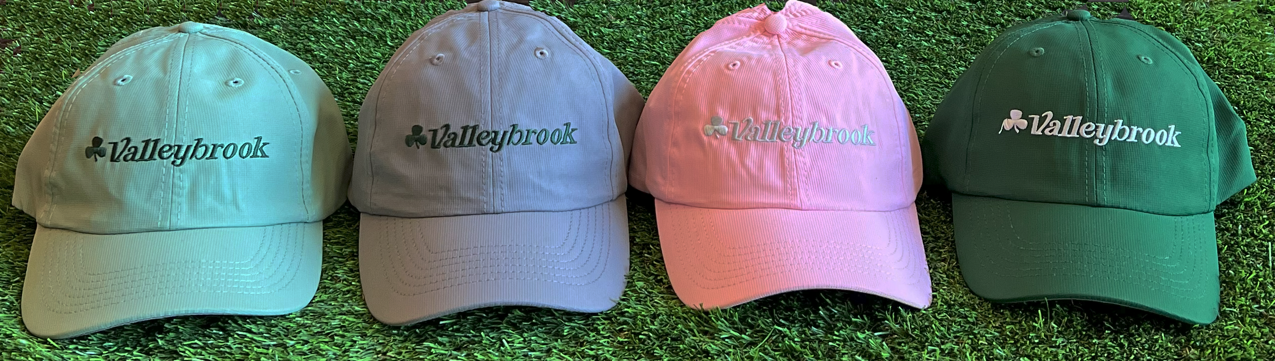 Valleybrook Club hats, including green, gray, and pink